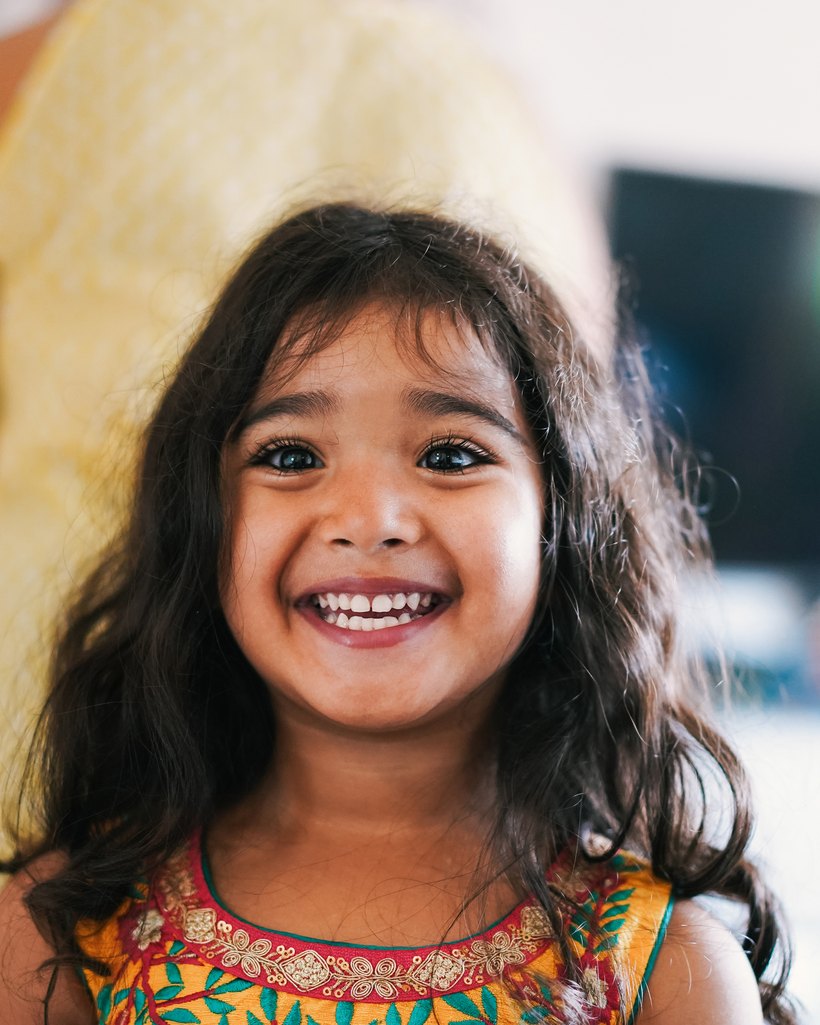 A smiling Little Ville child in the classroom